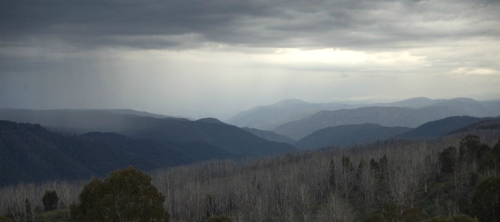 Rain showers over rolling mountains and stick forests in the Snowy Mountains NSW, Australia